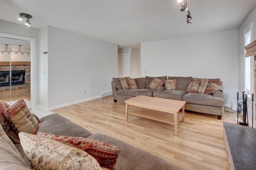 405 2 Avenue Nw, Diamond Valley, AB - Indoor Photo Showing Living Room With Fireplace