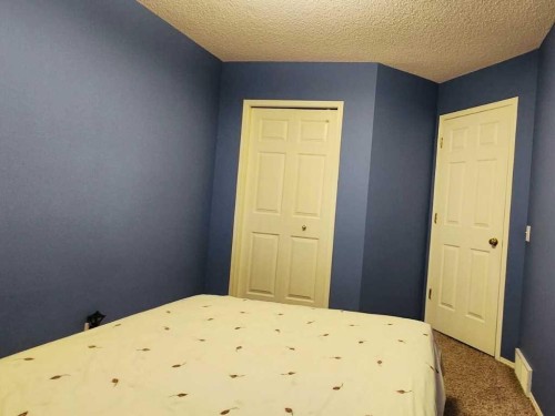 14954 Mt Mckenzie Drive Se, Calgary, AB - Indoor Photo Showing Bedroom