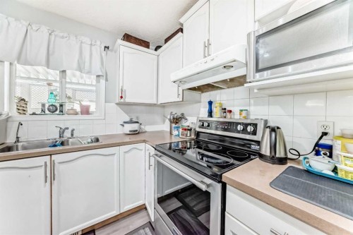 158 Bridleridge Circle Sw, Calgary, AB - Indoor Photo Showing Kitchen With Double Sink