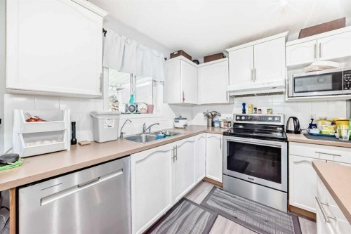 158 Bridleridge Circle Sw, Calgary, AB - Indoor Photo Showing Kitchen With Double Sink