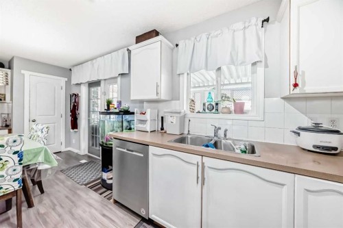 158 Bridleridge Circle Sw, Calgary, AB - Indoor Photo Showing Kitchen With Double Sink