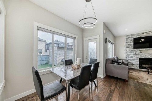 9 Saddlecrest Crescent Ne, Calgary, AB - Indoor Photo Showing Dining Room With Fireplace