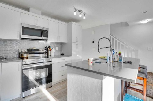 216 Windbury Lane Sw, Airdrie, AB - Indoor Photo Showing Kitchen With Stainless Steel Kitchen With Upgraded Kitchen