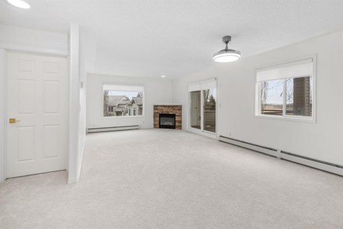 2205-7451 Springbank Boulevard Sw, Calgary, AB - Indoor With Fireplace