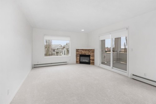 2205-7451 Springbank Boulevard Sw, Calgary, AB - Indoor Photo Showing Living Room With Fireplace