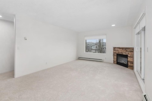 2205-7451 Springbank Boulevard Sw, Calgary, AB - Indoor With Fireplace