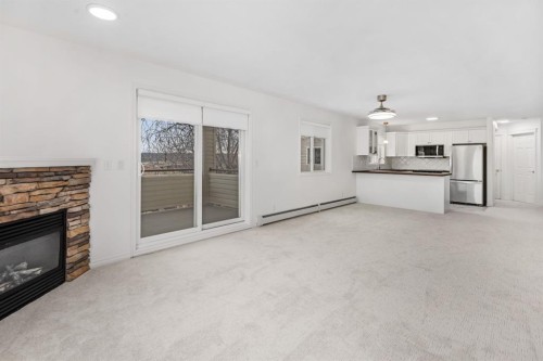 2205-7451 Springbank Boulevard Sw, Calgary, AB - Indoor Photo Showing Living Room With Fireplace