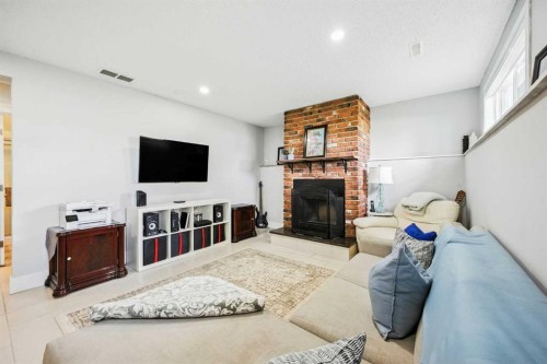 139 Huntford Green Ne, Calgary, AB - Indoor Photo Showing Living Room With Fireplace