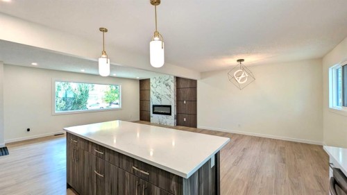 103 Haverhill Road Sw, Calgary, AB - Indoor Photo Showing Kitchen With Fireplace