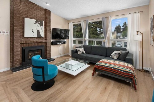 212 Woodbine Boulevard Sw, Calgary, AB - Indoor Photo Showing Living Room With Fireplace