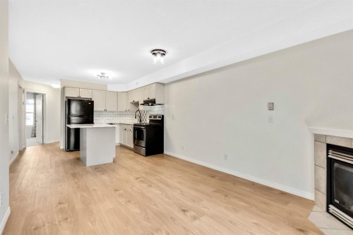 321-103 Strathaven Drive, Strathmore, AB - Indoor Photo Showing Kitchen With Fireplace
