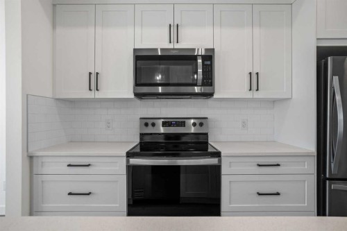 1604-525 River Heights Drive, Cochrane, AB - Indoor Photo Showing Kitchen With Stainless Steel Kitchen With Upgraded Kitchen