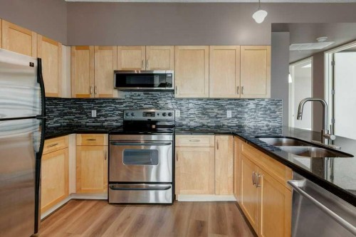 701-205 Riverfront Avenue Sw, Calgary, AB - Indoor Photo Showing Kitchen With Double Sink