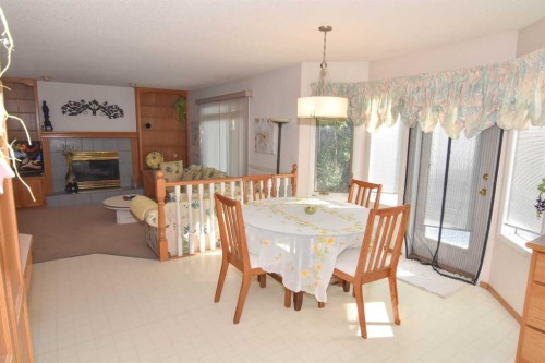 107 Hampshire Close Nw, Calgary, AB - Indoor Photo Showing Dining Room With Fireplace