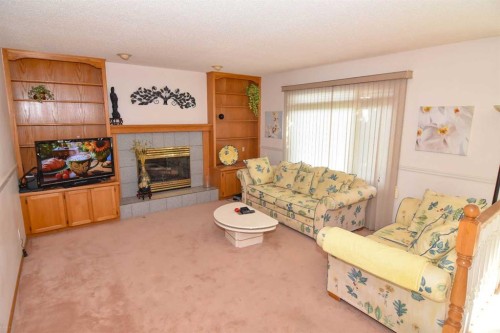 107 Hampshire Close Nw, Calgary, AB - Indoor Photo Showing Living Room With Fireplace