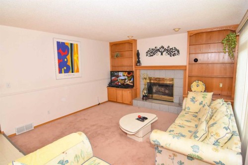 107 Hampshire Close Nw, Calgary, AB - Indoor Photo Showing Living Room With Fireplace