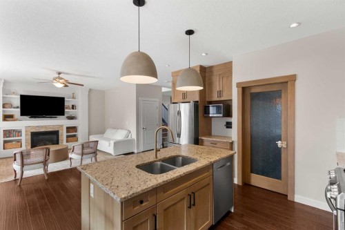 1535 Idaho Street, Carstairs, AB - Indoor Photo Showing Kitchen With Fireplace With Double Sink