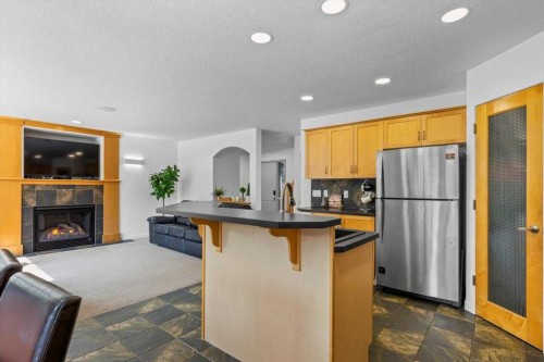 57 Everwillow Boulevard Sw, Calgary, AB - Indoor Photo Showing Kitchen With Fireplace