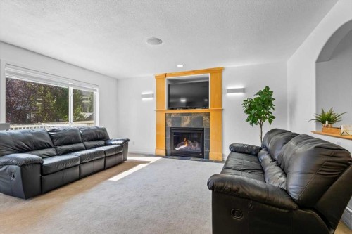 57 Everwillow Boulevard Sw, Calgary, AB - Indoor Photo Showing Living Room With Fireplace