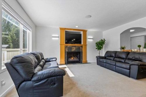 57 Everwillow Boulevard Sw, Calgary, AB - Indoor Photo Showing Living Room With Fireplace