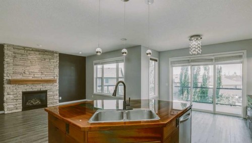 129 Pantego Bay Nw, Calgary, AB - Indoor Photo Showing Other Room With Fireplace