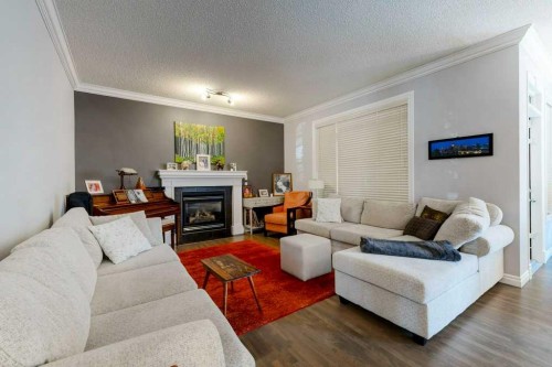 540 Panatella Court Nw, Calgary, AB - Indoor Photo Showing Living Room With Fireplace