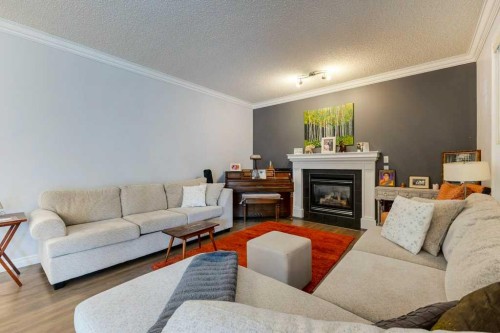 540 Panatella Court Nw, Calgary, AB - Indoor Photo Showing Living Room With Fireplace