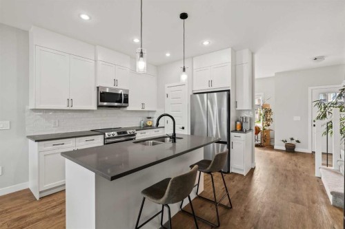 182 River Heights Drive, Cochrane, AB - Indoor Photo Showing Kitchen With Stainless Steel Kitchen With Double Sink With Upgraded Kitchen