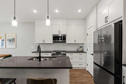 182 River Heights Drive, Cochrane, AB - Indoor Photo Showing Kitchen With Stainless Steel Kitchen With Double Sink With Upgraded Kitchen