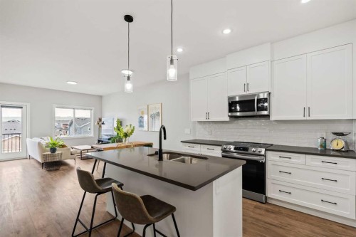 182 River Heights Drive, Cochrane, AB - Indoor Photo Showing Kitchen With Stainless Steel Kitchen With Double Sink With Upgraded Kitchen