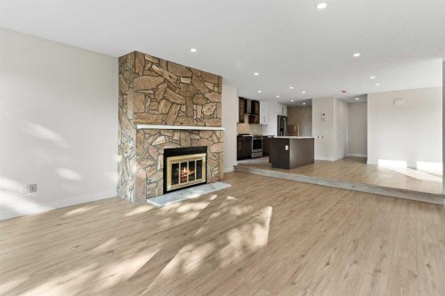 20-1220 Prominence Way Sw, Calgary, AB - Indoor Photo Showing Living Room With Fireplace