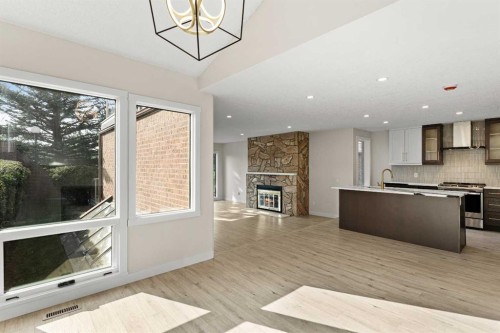 20-1220 Prominence Way Sw, Calgary, AB - Indoor Photo Showing Kitchen With Fireplace With Upgraded Kitchen