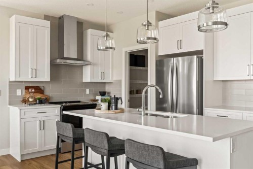 1168 Iron Ridge Avenue, Crossfield, AB - Indoor Photo Showing Kitchen With Stainless Steel Kitchen With Double Sink With Upgraded Kitchen