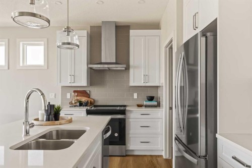 1168 Iron Ridge Avenue, Crossfield, AB - Indoor Photo Showing Kitchen With Stainless Steel Kitchen With Double Sink With Upgraded Kitchen