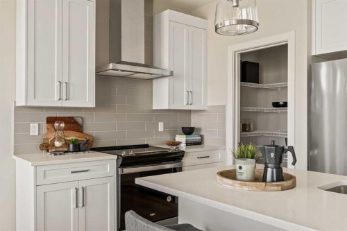 1168 Iron Ridge Avenue, Crossfield, AB - Indoor Photo Showing Kitchen With Upgraded Kitchen