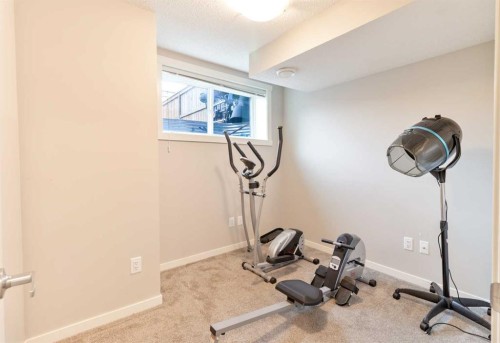 1016-7451 Falconridge Boulevard Ne, Calgary, AB - Indoor Photo Showing Gym Room