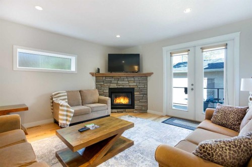 102-814 Memorial Drive Nw, Calgary, AB - Indoor Photo Showing Living Room With Fireplace
