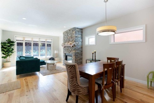 102-814 Memorial Drive Nw, Calgary, AB - Indoor Photo Showing Dining Room With Fireplace