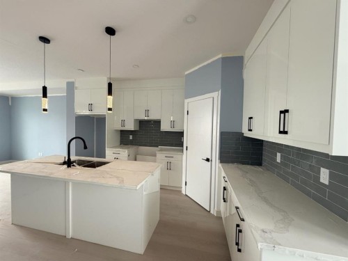 1999 Mccaskill Drive, Crossfield, AB - Indoor Photo Showing Kitchen With Double Sink With Upgraded Kitchen