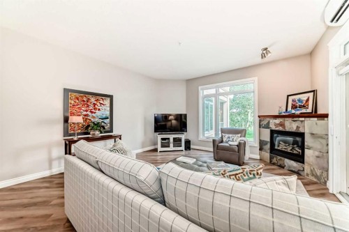 7204-14 Hemlock Crescent Sw, Calgary, AB - Indoor Photo Showing Living Room With Fireplace