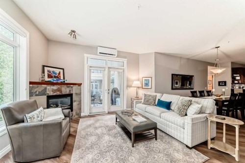 7204-14 Hemlock Crescent Sw, Calgary, AB - Indoor Photo Showing Living Room With Fireplace