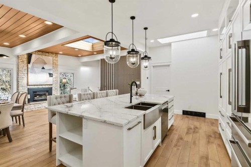 2332 Uxbridge Drive Nw, Calgary, AB - Indoor Photo Showing Kitchen With Fireplace With Double Sink With Upgraded Kitchen