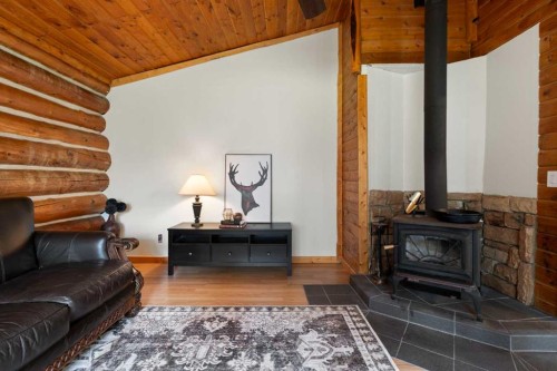 4-29415 Range Road 52, Rural Mountain View County, AB - Indoor Photo Showing Living Room With Fireplace