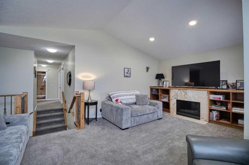 409 9 Street, Beiseker, AB - Indoor Photo Showing Other Room With Fireplace