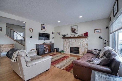 409 9 Street, Beiseker, AB - Indoor Photo Showing Living Room With Fireplace
