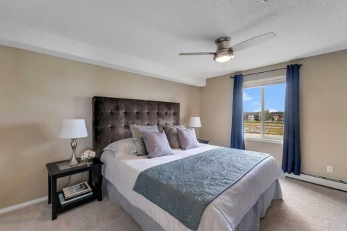 8328-304 Mackenzie Way Sw, Airdrie, AB - Indoor Photo Showing Bedroom
