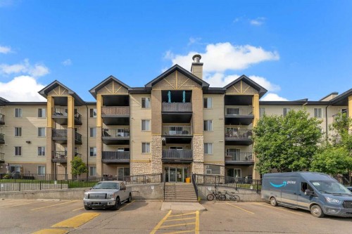 8328-304 Mackenzie Way Sw, Airdrie, AB - Outdoor With Balcony With Facade