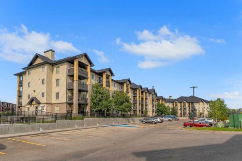 8328-304 Mackenzie Way Sw, Airdrie, AB - Outdoor With Balcony With Facade