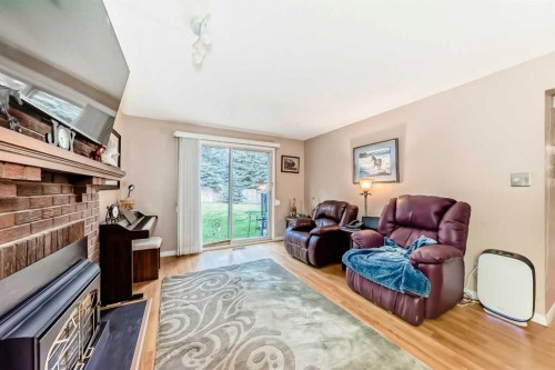 983 Woodbine Boulevard Sw, Calgary, AB - Indoor Photo Showing Living Room With Fireplace