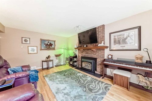 983 Woodbine Boulevard Sw, Calgary, AB - Indoor Photo Showing Living Room With Fireplace